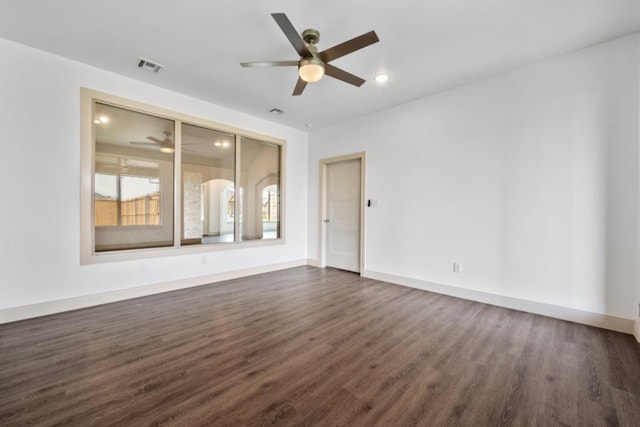 empty room featuring ceiling fan and dark hardwood / wood-style flooring