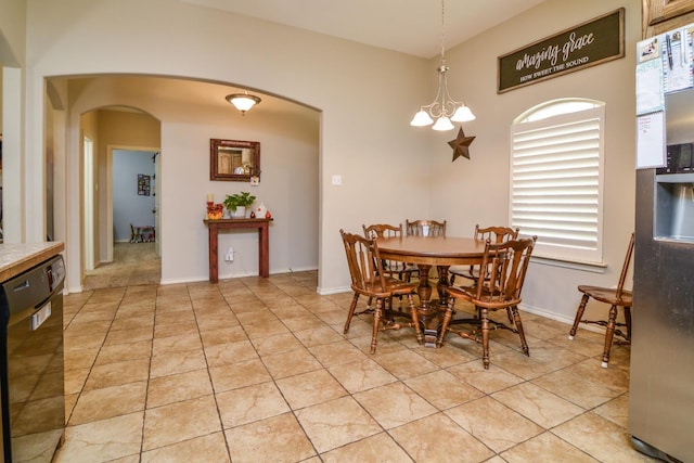 dining room with light tile patterned flooring and a chandelier