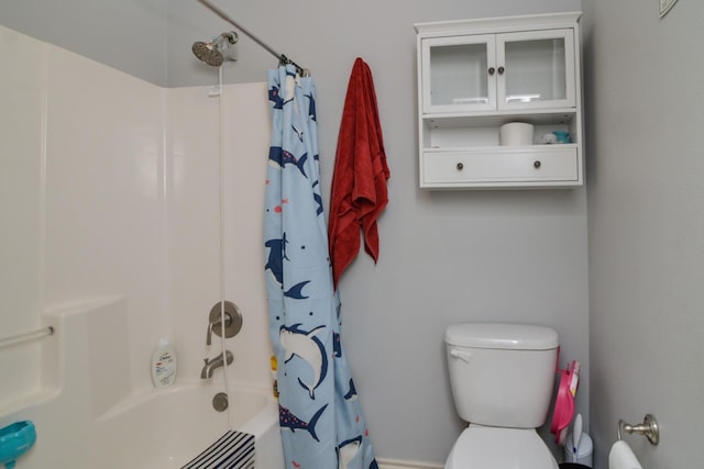 bathroom with shower / bath combination with curtain and toilet