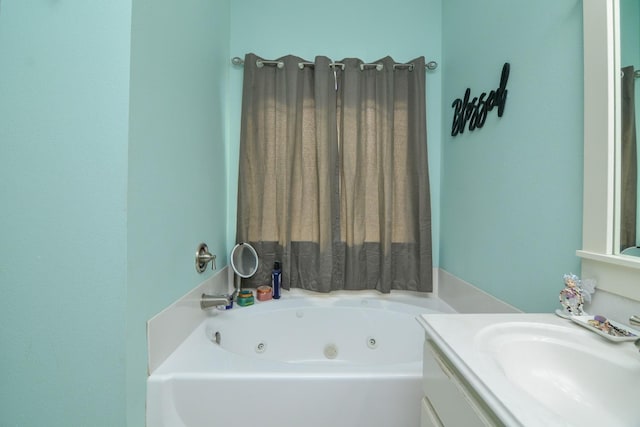 bathroom featuring vanity and a washtub