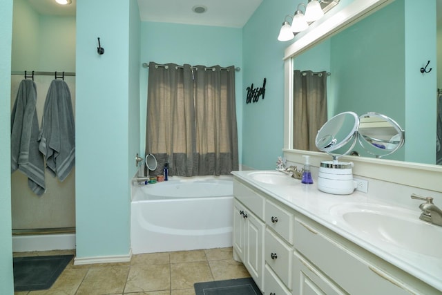 bathroom with tile patterned flooring, a tub to relax in, and vanity