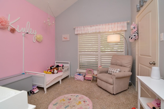 carpeted bedroom featuring lofted ceiling, a nursery area, and a chandelier