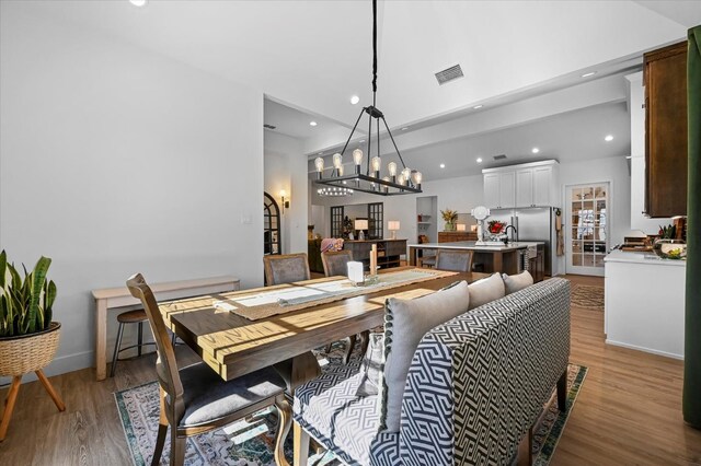 dining area with a notable chandelier and light wood-type flooring