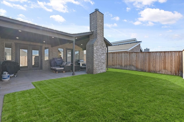 view of yard featuring an outdoor hangout area, a patio, and french doors