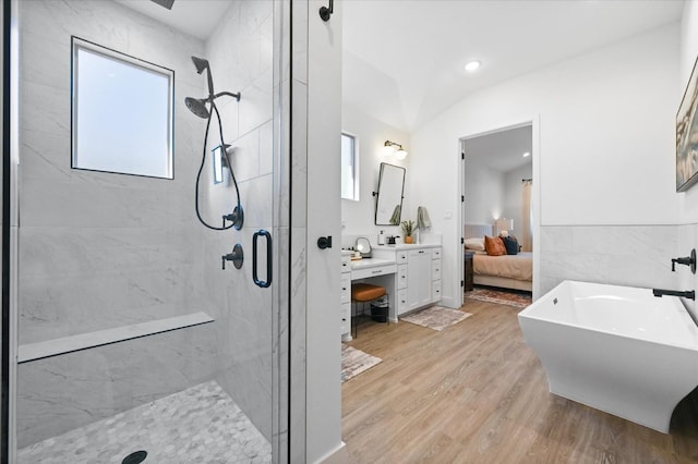 bathroom with an enclosed shower, vanity, and hardwood / wood-style flooring