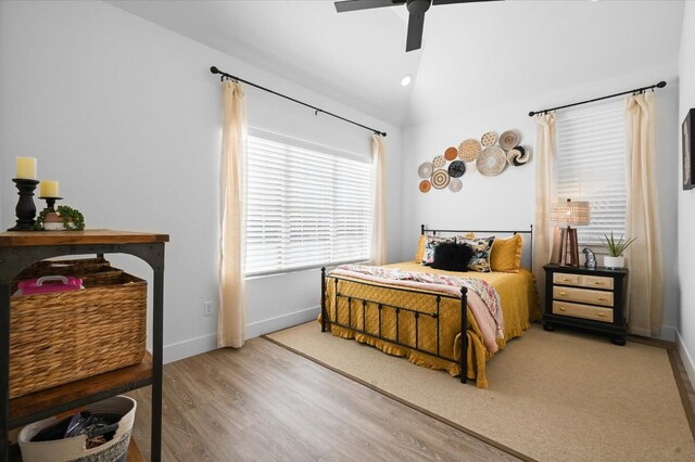 bedroom featuring ceiling fan, lofted ceiling, and hardwood / wood-style floors