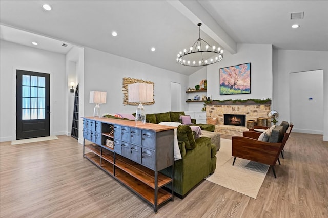 living room with a fireplace, light hardwood / wood-style flooring, and vaulted ceiling with beams