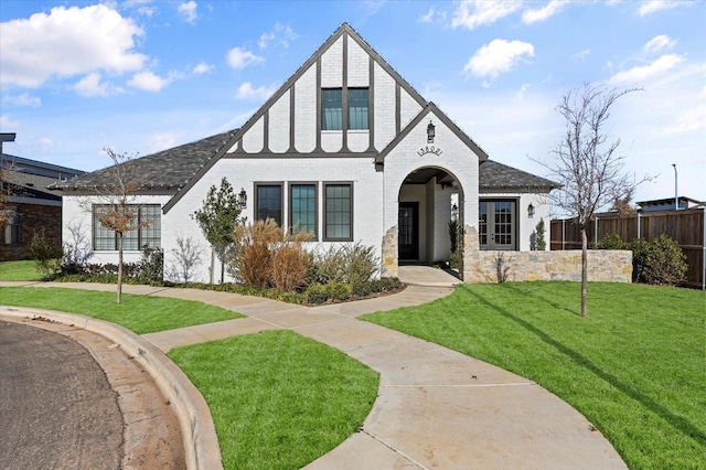 tudor home featuring a front yard