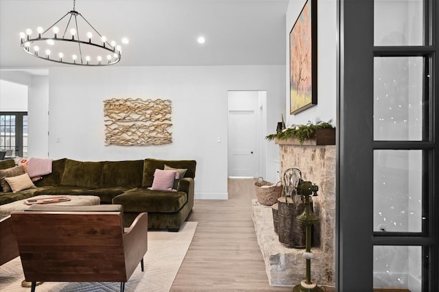 living room featuring a notable chandelier and light hardwood / wood-style floors