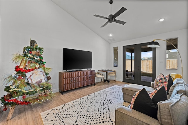 living room featuring lofted ceiling, hardwood / wood-style floors, french doors, and ceiling fan