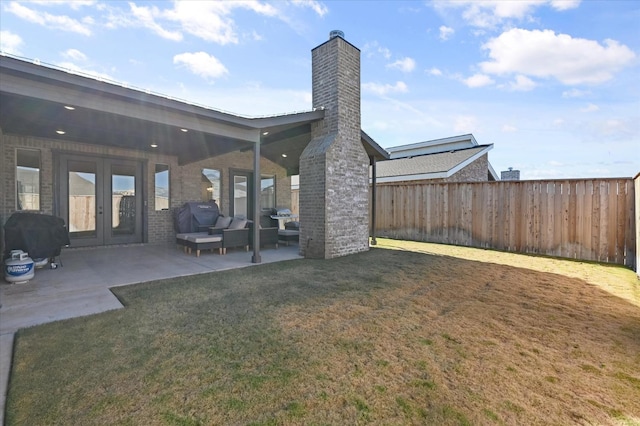 view of yard with a patio and french doors