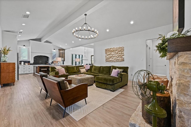 living room featuring lofted ceiling with beams and light wood-type flooring