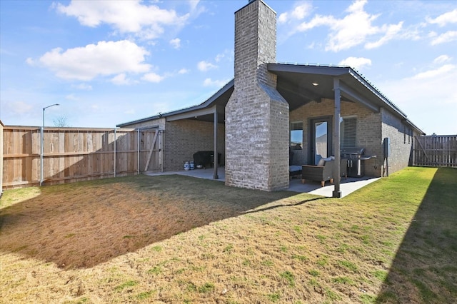 rear view of house with a yard and a patio