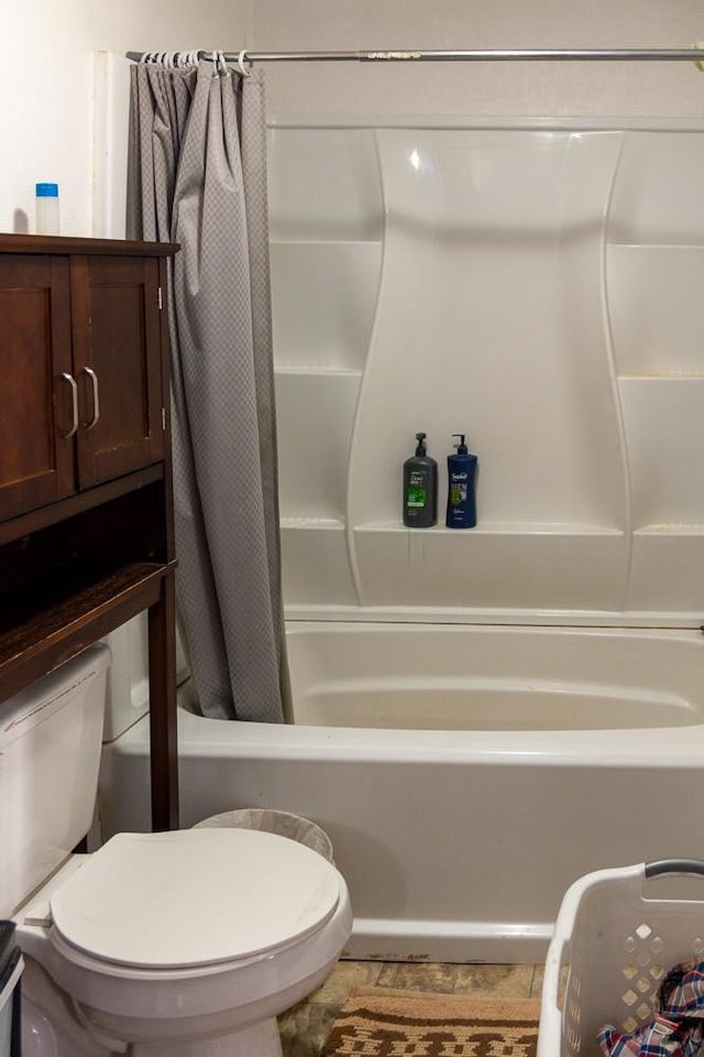 bathroom featuring shower / bathtub combination with curtain, toilet, and tile patterned flooring