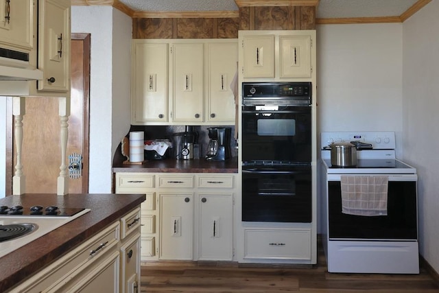 kitchen featuring electric range, dark hardwood / wood-style floors, black double oven, and ventilation hood