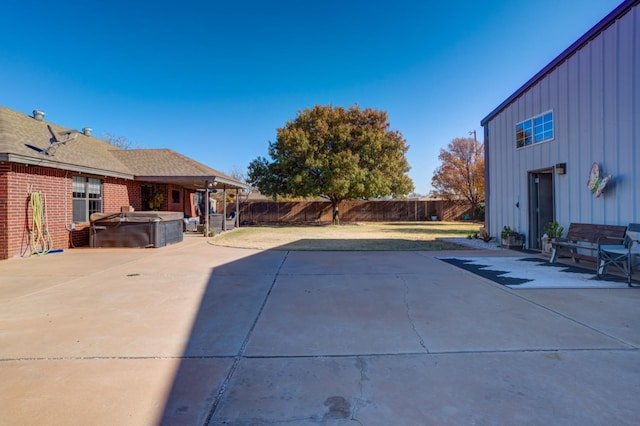 view of pool with a hot tub and a patio