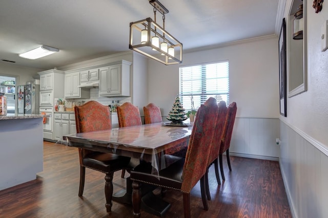 dining room featuring ornamental molding and dark hardwood / wood-style floors