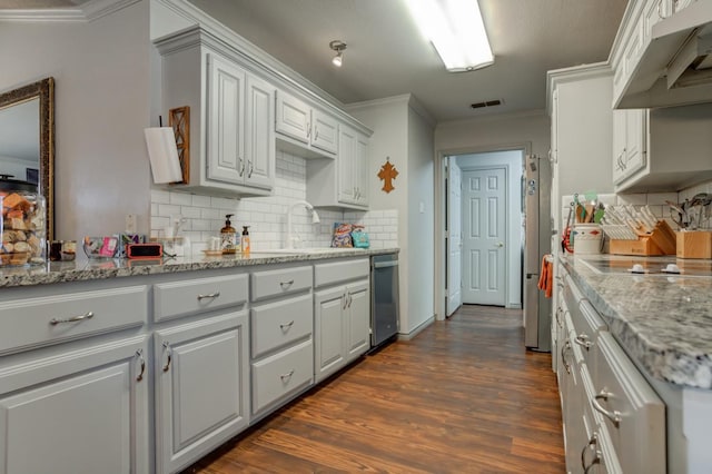 kitchen featuring sink, dark hardwood / wood-style flooring, ornamental molding, light stone counters, and stainless steel appliances