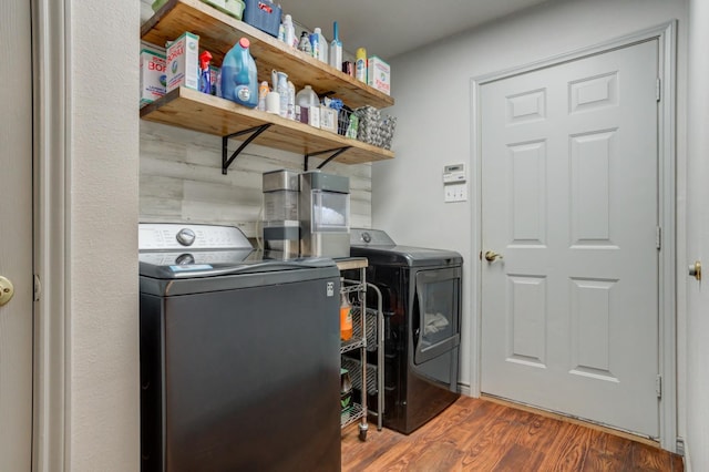 laundry area with separate washer and dryer and dark wood-type flooring