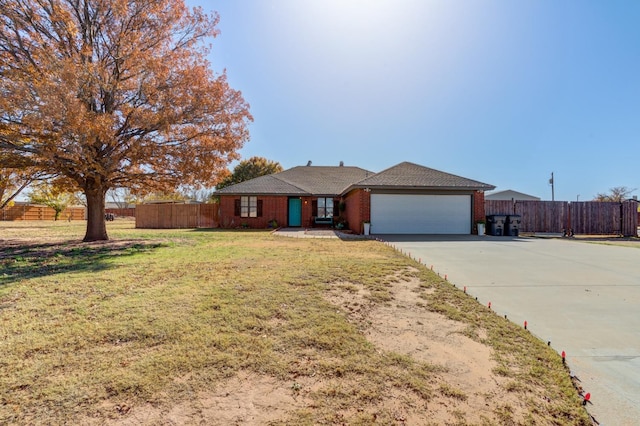 ranch-style house featuring a garage and a front yard