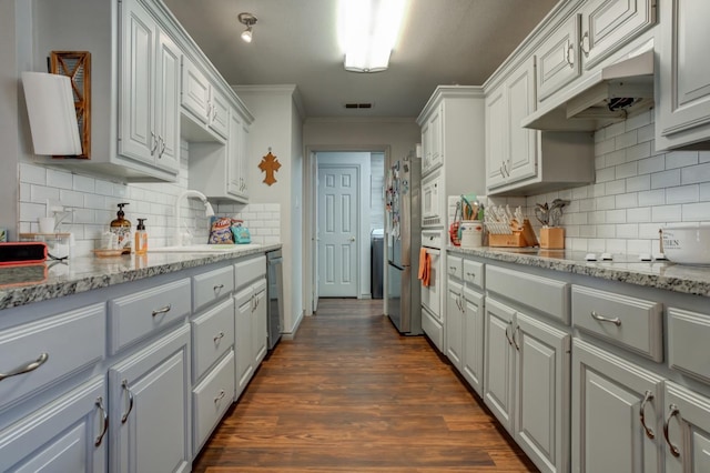 kitchen featuring dark hardwood / wood-style floors, dishwasher, sink, ornamental molding, and light stone countertops