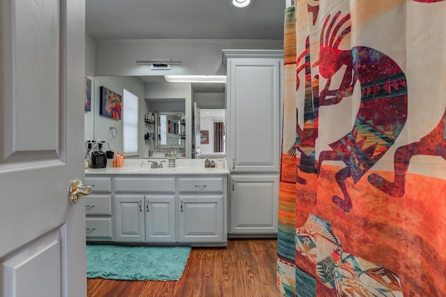 bathroom with vanity and hardwood / wood-style flooring