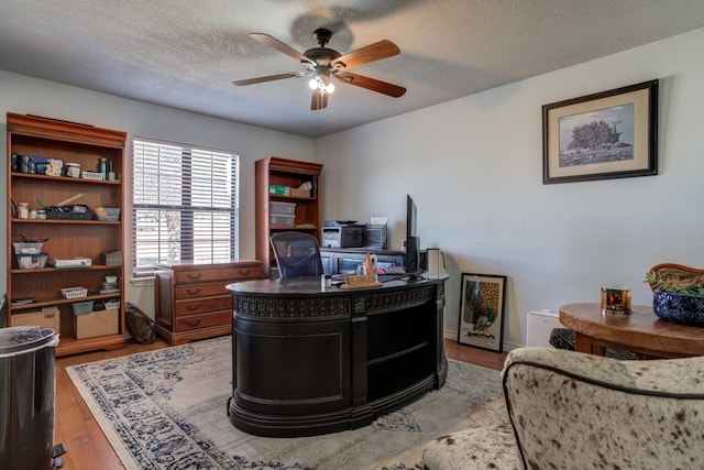 office area featuring hardwood / wood-style floors, a textured ceiling, and ceiling fan