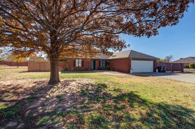 ranch-style house featuring a garage and a front lawn