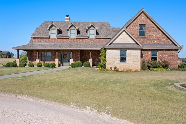 8405 E County Rd 6100, Idalou, TX 79329 - view of front of home featuring a front lawn, a chimney, roof with shingles, and brick siding
