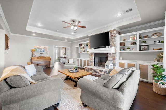 8405 E County Rd 6100, Idalou, TX 79329 - living room featuring wood finished floors, ceiling fan, a raised ceiling, a fireplace, and recessed lighting
