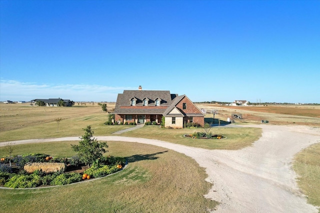 8405 E County Rd 6100, Idalou, TX 79329 - view of front of home with curved driveway, a front lawn, and brick siding
