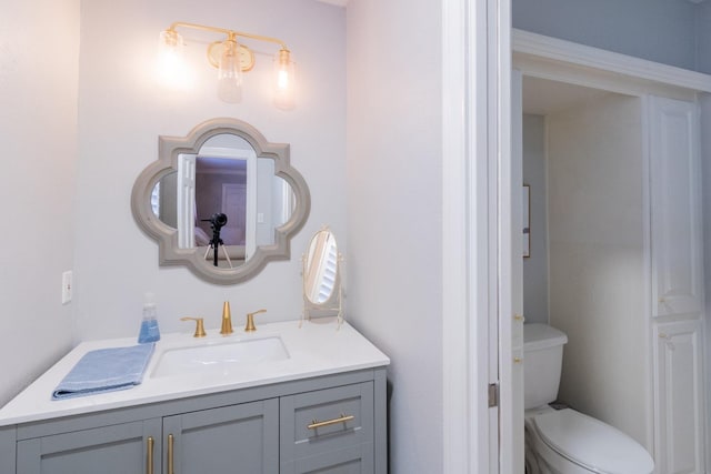 bathroom featuring vanity and toilet