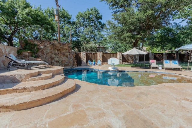 view of swimming pool with a patio