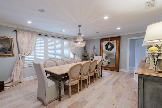 dining room with light hardwood / wood-style flooring and ornamental molding