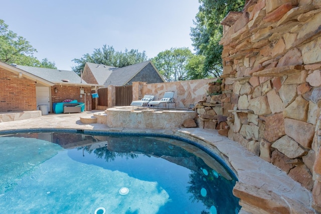 view of pool with a jacuzzi and a patio area