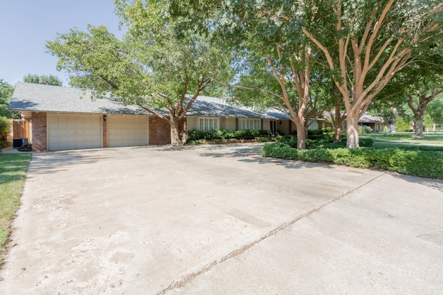 single story home with a garage and central AC