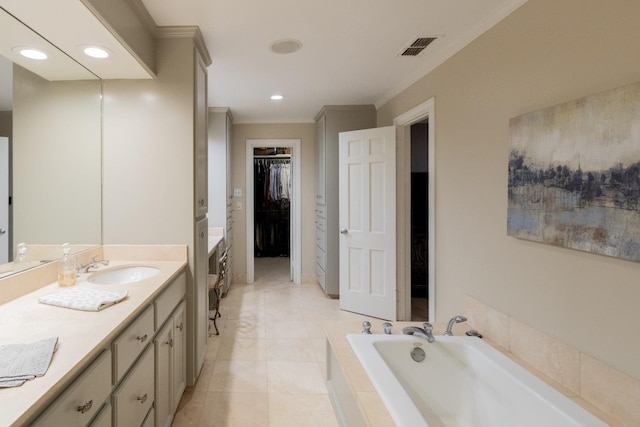 bathroom with vanity, tile patterned floors, ornamental molding, and tiled bath