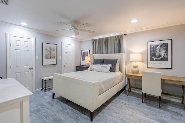 bedroom with hardwood / wood-style flooring, ornamental molding, and ceiling fan