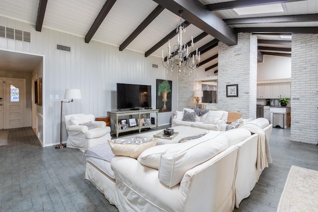 living room featuring an inviting chandelier, beam ceiling, and high vaulted ceiling