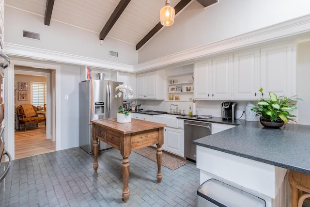 kitchen featuring tasteful backsplash, sink, white cabinets, stainless steel appliances, and beam ceiling