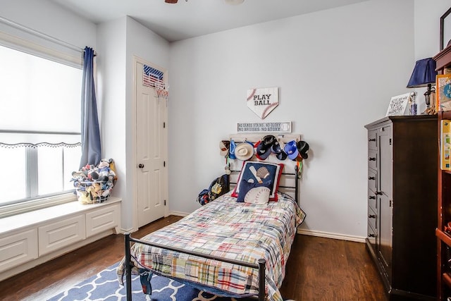 bedroom with dark hardwood / wood-style flooring