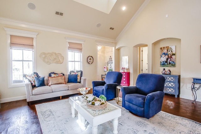 living room with dark hardwood / wood-style flooring, high vaulted ceiling, and ornamental molding