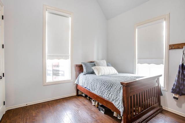 bedroom with vaulted ceiling and dark hardwood / wood-style floors