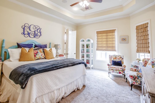 bedroom with ornamental molding, carpet flooring, ceiling fan, and a tray ceiling