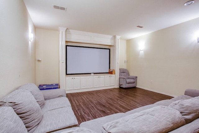 cinema room featuring dark wood-type flooring