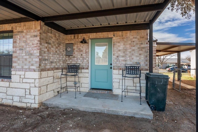 entrance to property featuring fence