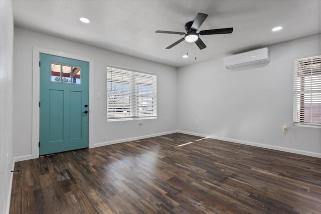 foyer featuring recessed lighting, baseboards, dark wood finished floors, and a wall mounted air conditioner