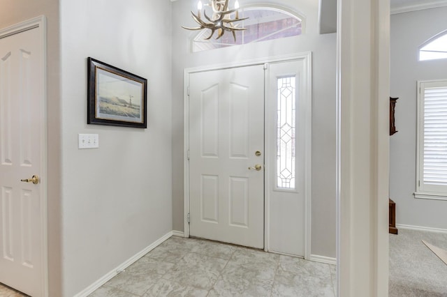 entrance foyer featuring a notable chandelier and a healthy amount of sunlight