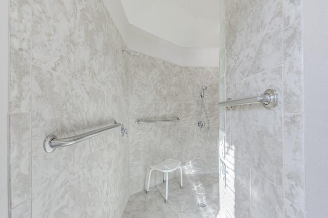 bathroom with a tile shower