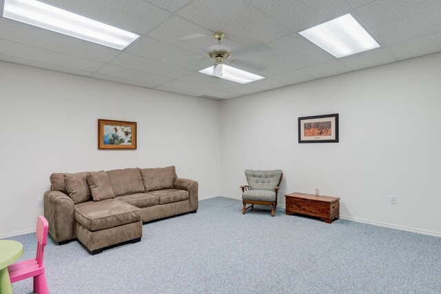 carpeted living room with ceiling fan